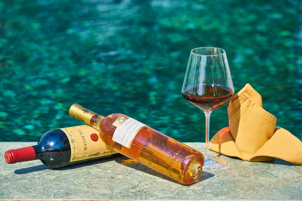 Sophisticated wine setting by the pool, perfect for relaxation and celebration.