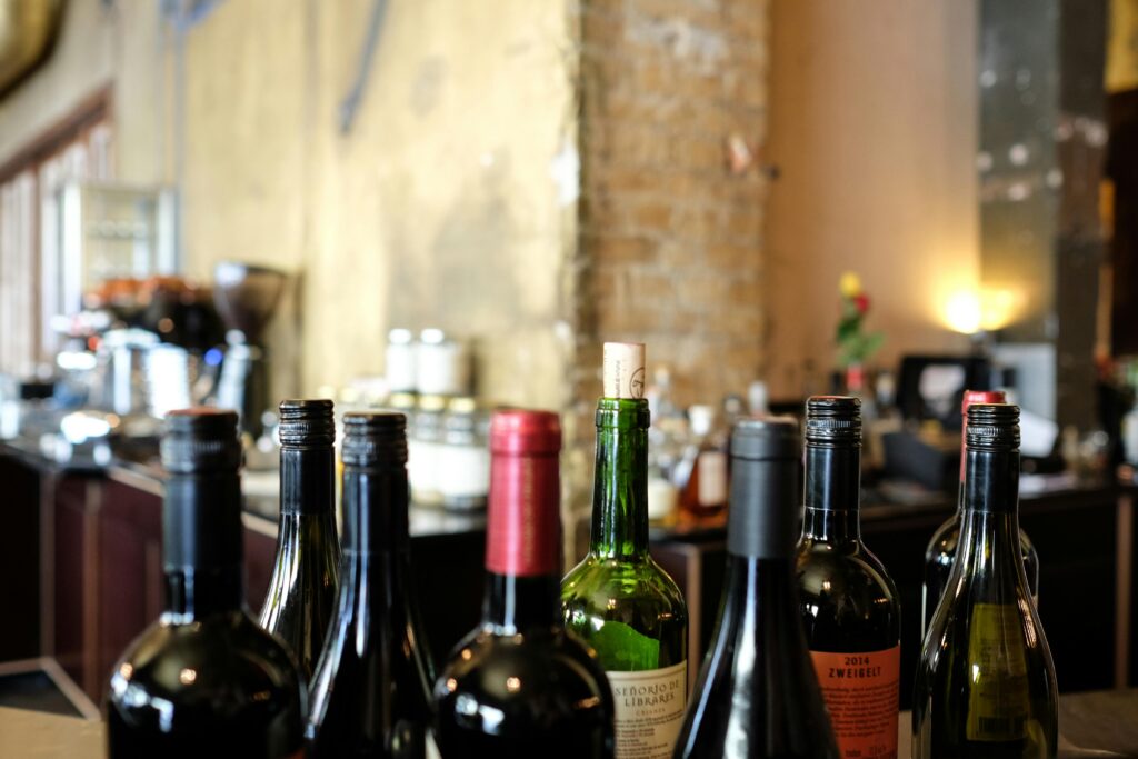 A selection of wine bottles with corks on a restaurant bar counter, ideal for gastronomy themes.